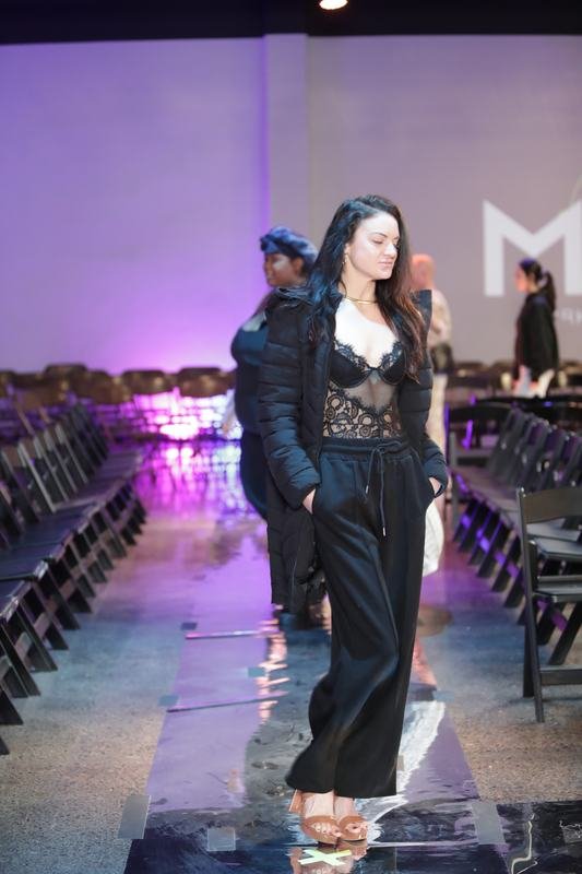 Model striking a pose on the runway at Le Pasefika Runway 2025